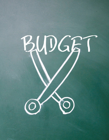 budget cut sign on blackboardの写真素材