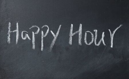 happy hour text write on blackboardの写真素材
