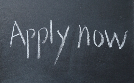 apply now text write on blackboardの写真素材