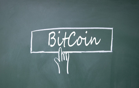 finger click bitcoin sign on blackboardの写真素材