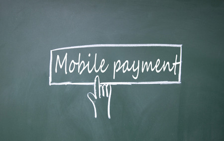 finger click mobile payment symbol on blackboardの写真素材
