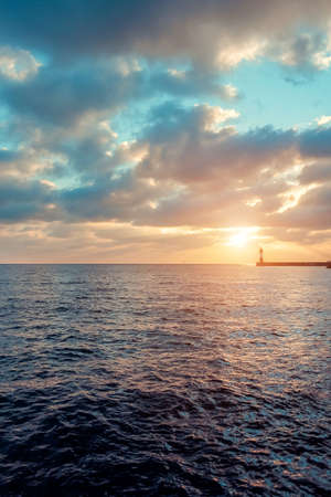 Lighthouse in the sea at sunset. Duskの写真素材