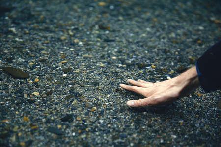 Touching the water. Hand in water. Pure water. Transparent pond. Pond in the mountains. Riverの写真素材