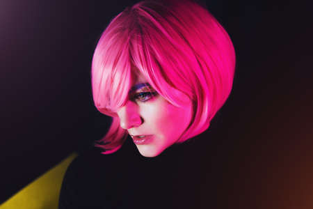 Fashion sexy woman pink hair. Pink light. Life style. Retro wave neon noir lights color toningtの写真素材