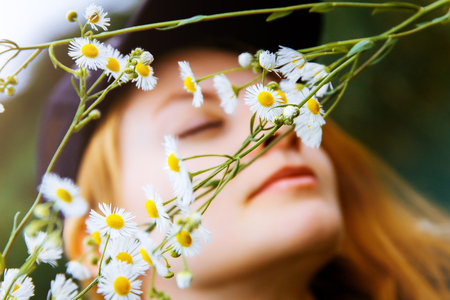 Young beautiful girl in flowers. Chamomile. Summer Spring