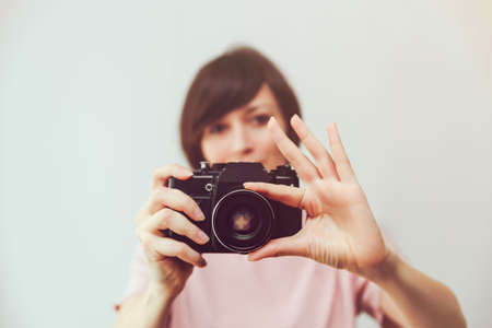 Pretty girl with Vintage Camera. Photo. Photographer. Manual focusの写真素材