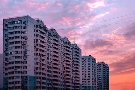 Sunset. high rise with a lot of windows. Beautiful pink purple sky
