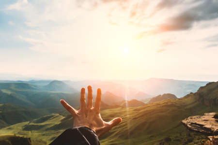 Hand touching Mountains sunset landscape emotional Travel Lifestyle wanderlust freedom concept adventure summer vacations outdoor calm harmony with natureの写真素材