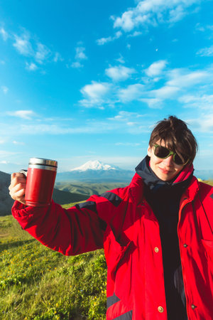 Summer vacations woman in glasses traveling Caucasian mountains Elbrus holding tea cup lifestyle...