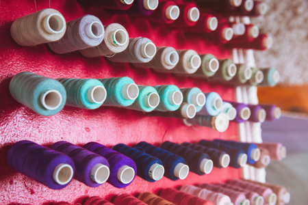 multi color Spools of thread needlework, sewing, tailoring and tailoring concept.