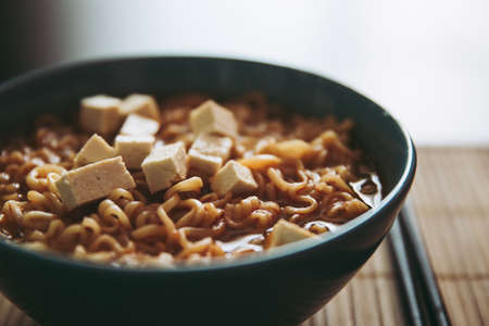 Hot tasty ramen with tofu in bowl home cooking steamの写真素材