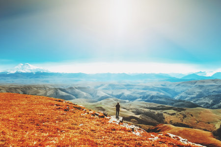 A man walks along the valley. Elbrus Caucasian ridge. Mountain landscape.の写真素材