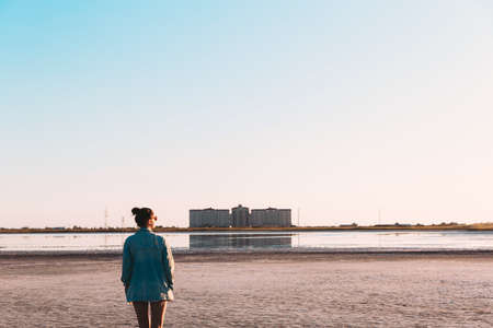 Young stylish hipster girl Jeans jacket Sunset coast single during travel summer holidays vacation outdoorsの写真素材