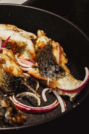 Pan-fried white fish steaks. Pelengas. Home cooking. Close-upの写真素材