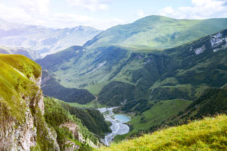 Beautiful view of green alpine meadows with a lake. Georgia, Europe. Caucasus mountains landscape. Beauty world. Travel conceptの写真素材