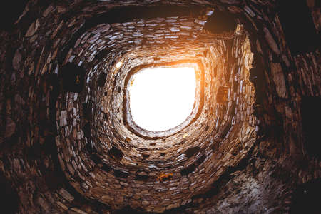 Stone tower tunnel. View of the sky from belowの写真素材