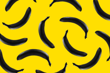 Black banana on a yellow background Pattern texture. design Pop artの写真素材