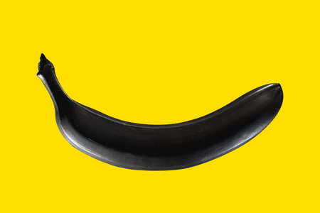 Black banana on a yellow background Pop artの写真素材