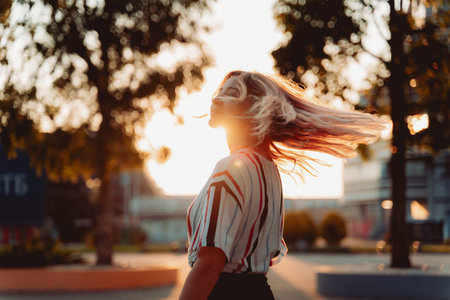 Attractive blonde girl smiling at sunset. Happy Hipster lifestyle