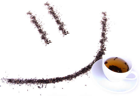 A "tea smile" and a cup of tea on a white isolated backgroundの写真素材