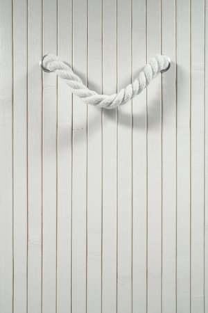 Wooden background with white boards and nice handles made of thick ropeの写真素材