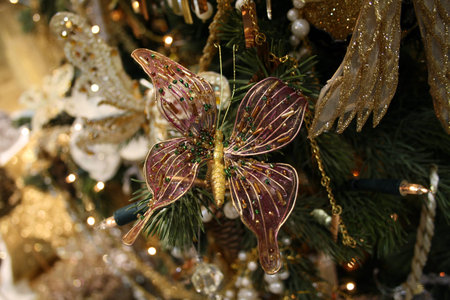 Christmas fur-tree decorated by the toy pink butterfly with ballsの写真素材