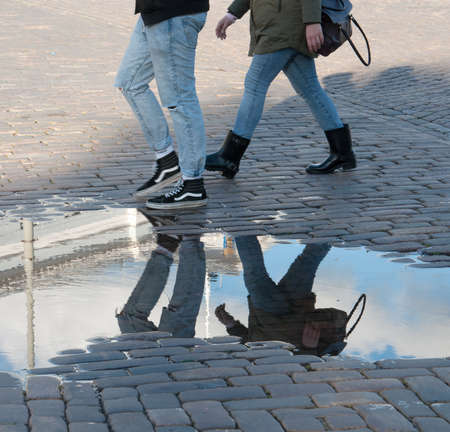 Reflection of walking people after rainの写真素材
