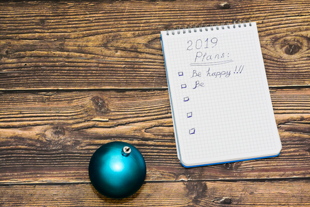 Happy New Year card with decoration and 2019 to do list on wooden backgroundの写真素材