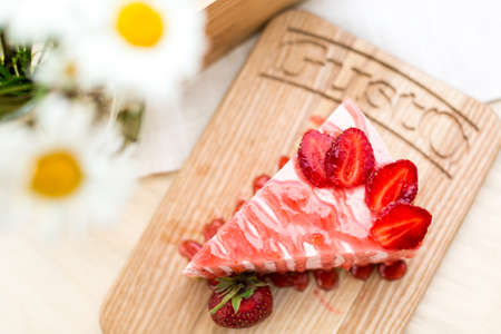 cake with strawberries on a brown backgroundの写真素材