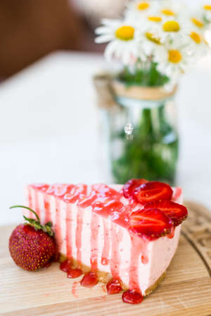 cake with strawberries on a brown backgroundの写真素材