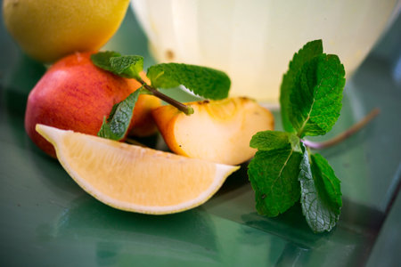 Preparation of the lemonade drink lemons with mint on the table