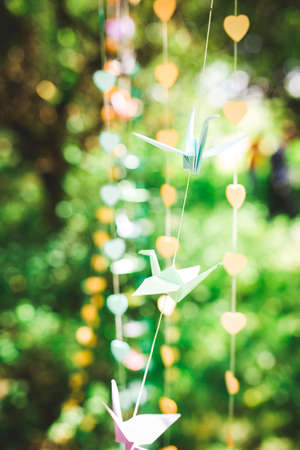 Origami crane, paper birds on bokeh background. shallow deep of field.の写真素材