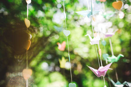 Origami crane, paper birds on bokeh background. shallow deep of field.の写真素材