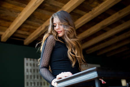 beautiful stylish young woman (girl) in black dressの写真素材