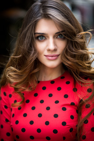 Beautiful brunette young woman wearing dress and walking on the streetの写真素材
