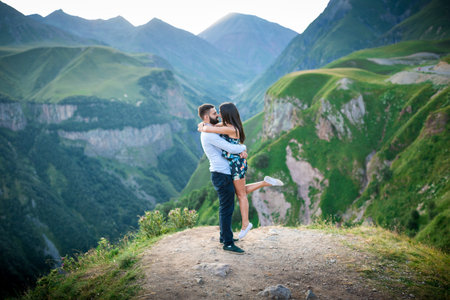 beautiful young couple in love in the mountains