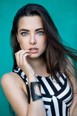 Outdoor summer portrait of young pretty cute brunette girl. Beautiful woman posing in spring.