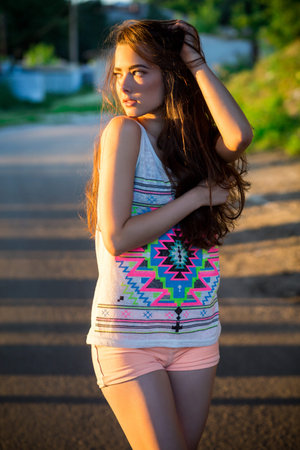 Outdoor summer portrait of young pretty cute brunette girl. Beautiful woman posing in spring.の写真素材