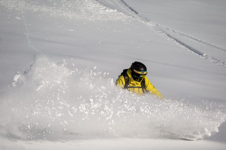 Man snowboarding on snow in the mountainsの写真素材