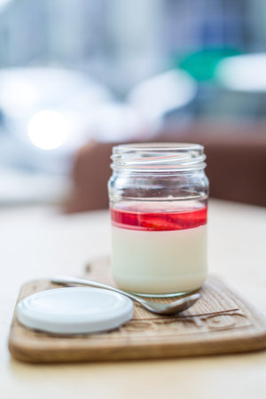 Beautiful strawberry dessert in a jar on light Board