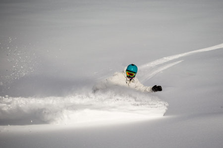 Man snowboarding on snow in the mountainsの写真素材