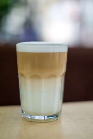 beautiful cappuccino, latte,coffee in a glass Cup on a checkered tableclothの写真素材