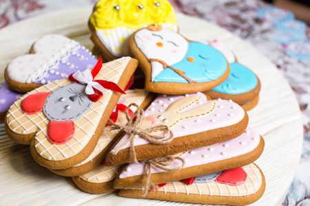 a collection of gingerbread cookies in the shape of a heart, muffins and animals on a white wooden backgroundの写真素材