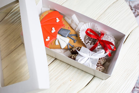 a collection of gingerbread cookies in the shape of a heart, muffins and animals on a white wooden...
