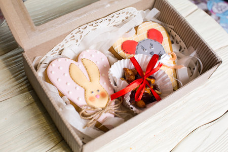 a collection of gingerbread cookies in the shape of a heart, muffins and animals on a white wooden...