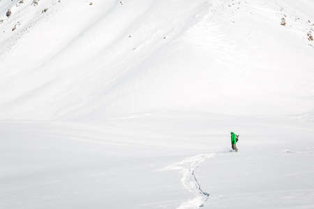 Man snowboarding on snow in the mountainsの写真素材