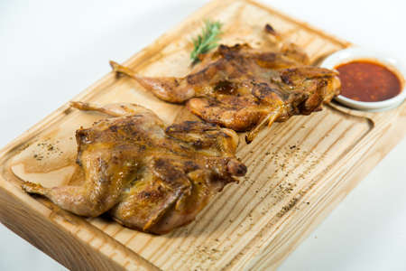 Beautiful juicy chicken grilled with sauce on a wooden Boardの写真素材