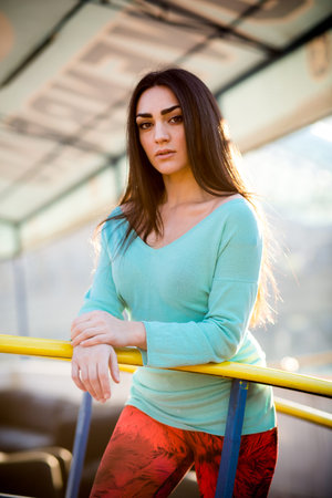 Beautiful brunette young woman  posing on the street