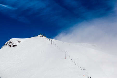 Beautiful blue skies with clouds over the mountains in the snow. Winter landscapeの写真素材