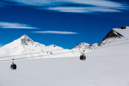Beautiful blue skies with clouds over the mountains in the snow. Winter landscapeの写真素材